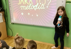 dziewczynka śpiewa piosenkę przy użyciu mikrofonu