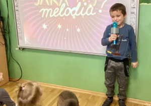 chłopiec śpiewa piosenkę przy użyciu mikrofonu