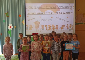 dzieci z grupy III w tle baner na którym widnieje napis:" Dobre maniey to klucz do kariery"
