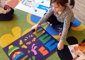 dzieci ubierają lalkę