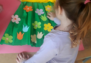 Oliwia przykleja kwiatki na sukni