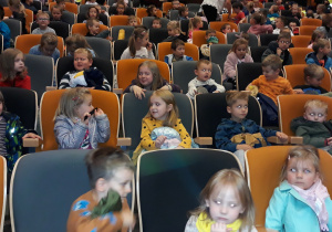 dzieci siedzą na widowni