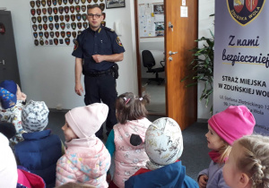 przedszkolaki z wizytą w siedzibie straży miejskiej, słuchają wiadomości i o pracy strażników