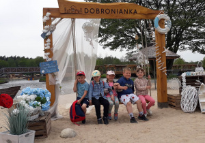 dzieci siedzą na huśtawce z napisem Dobronianka