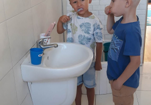 chłopcy myją zęby