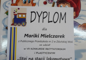 dyplom oraz nagroda książkowa dla Mariki Mielczarek za udział w konkursie plastycznym i recytatorskim "Stoi na stacji lokomotywa"