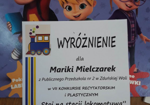 wyróżnienie oraz nagroda książkowa dla Mariki Mielczarek za udział w konkursie plastycznym i recytatorskim "Stoi na stacji lokomotywa"